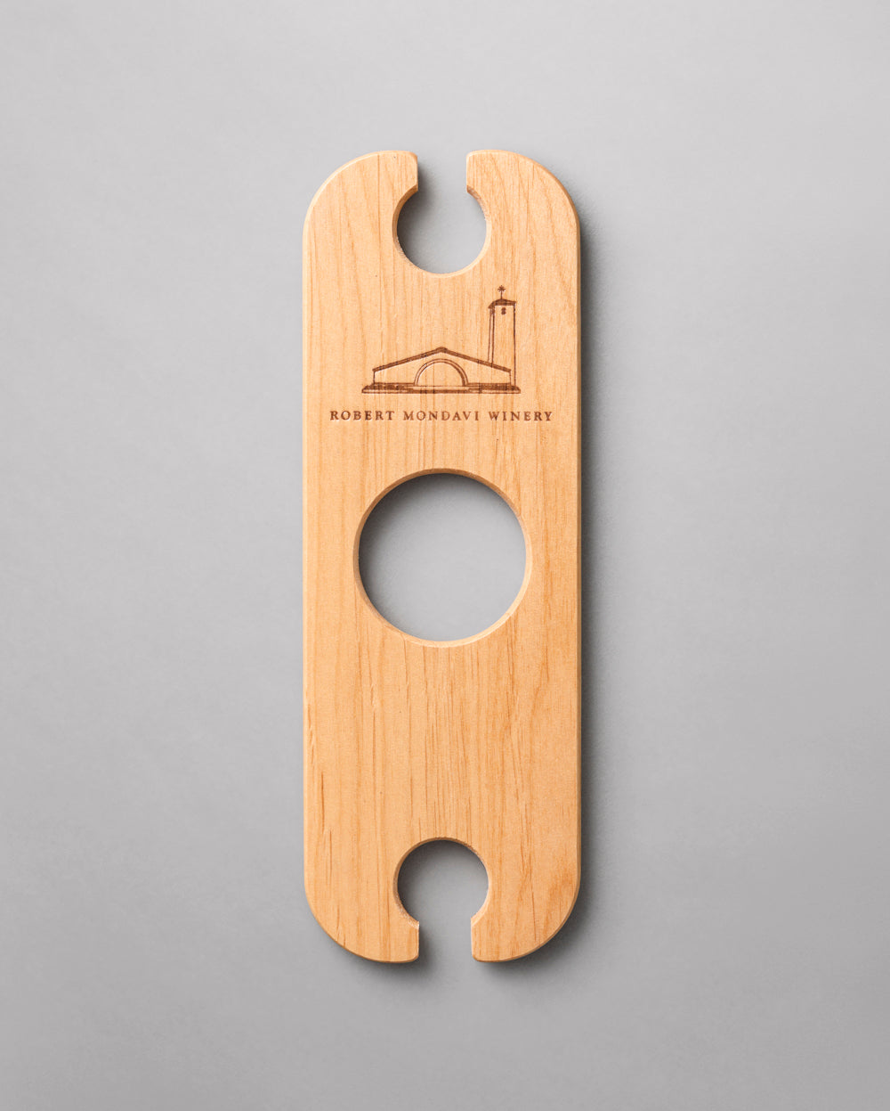 A wooden  Wine Butler that holds two glasses and balances on the neck of a bottle of wine.