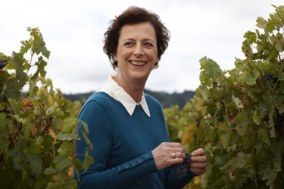 Geneviève Janssens, Chief Winemaker for Robert Mondavi smiling amidst the grapevines.