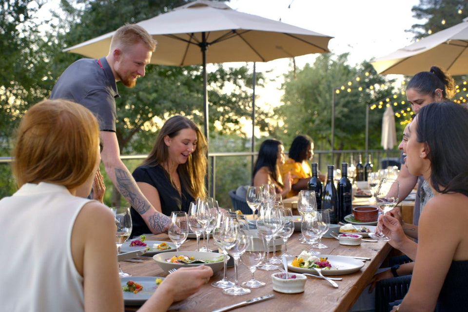 Dinner party happening outdoors by the river