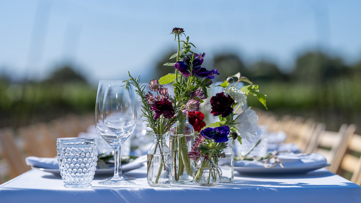 Table setting with flowers and glasses outdoors