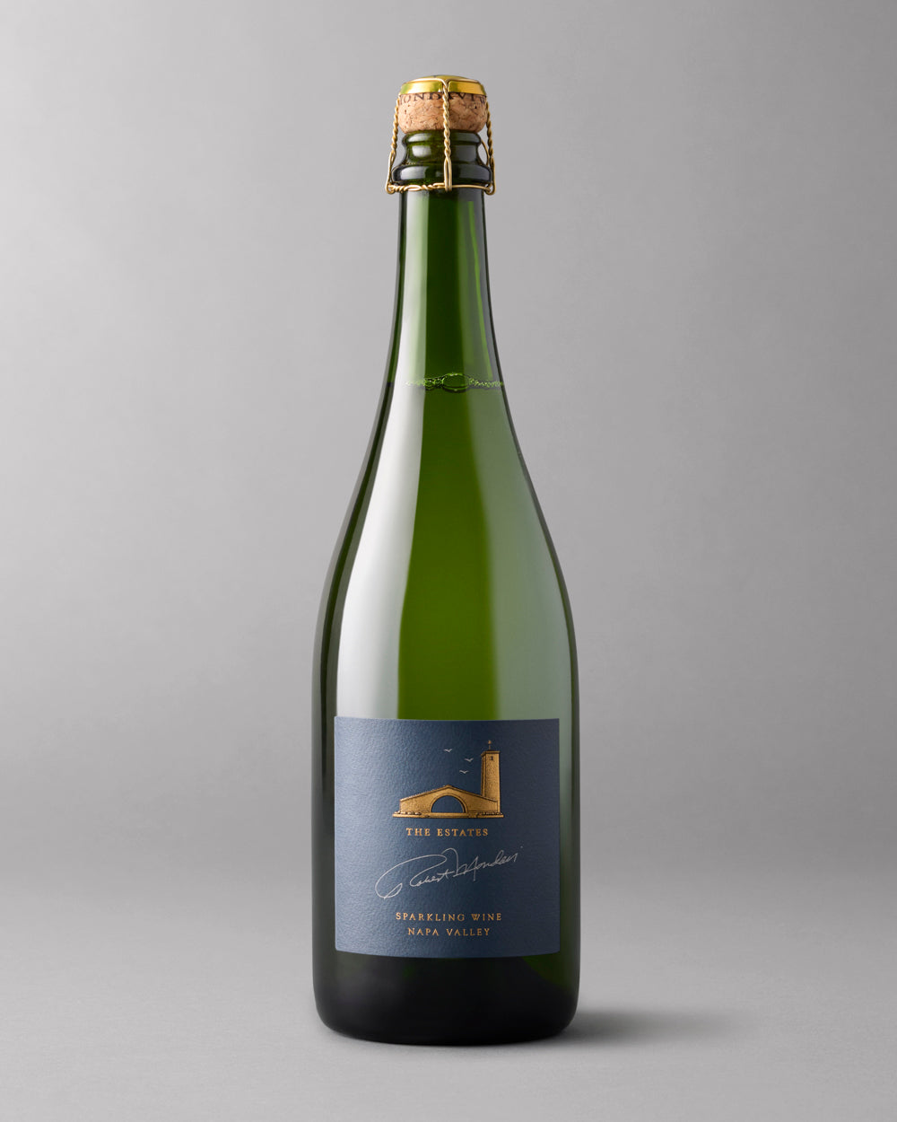 Single bottle of Robert Mondavi Estate sparkling wine on a grey background