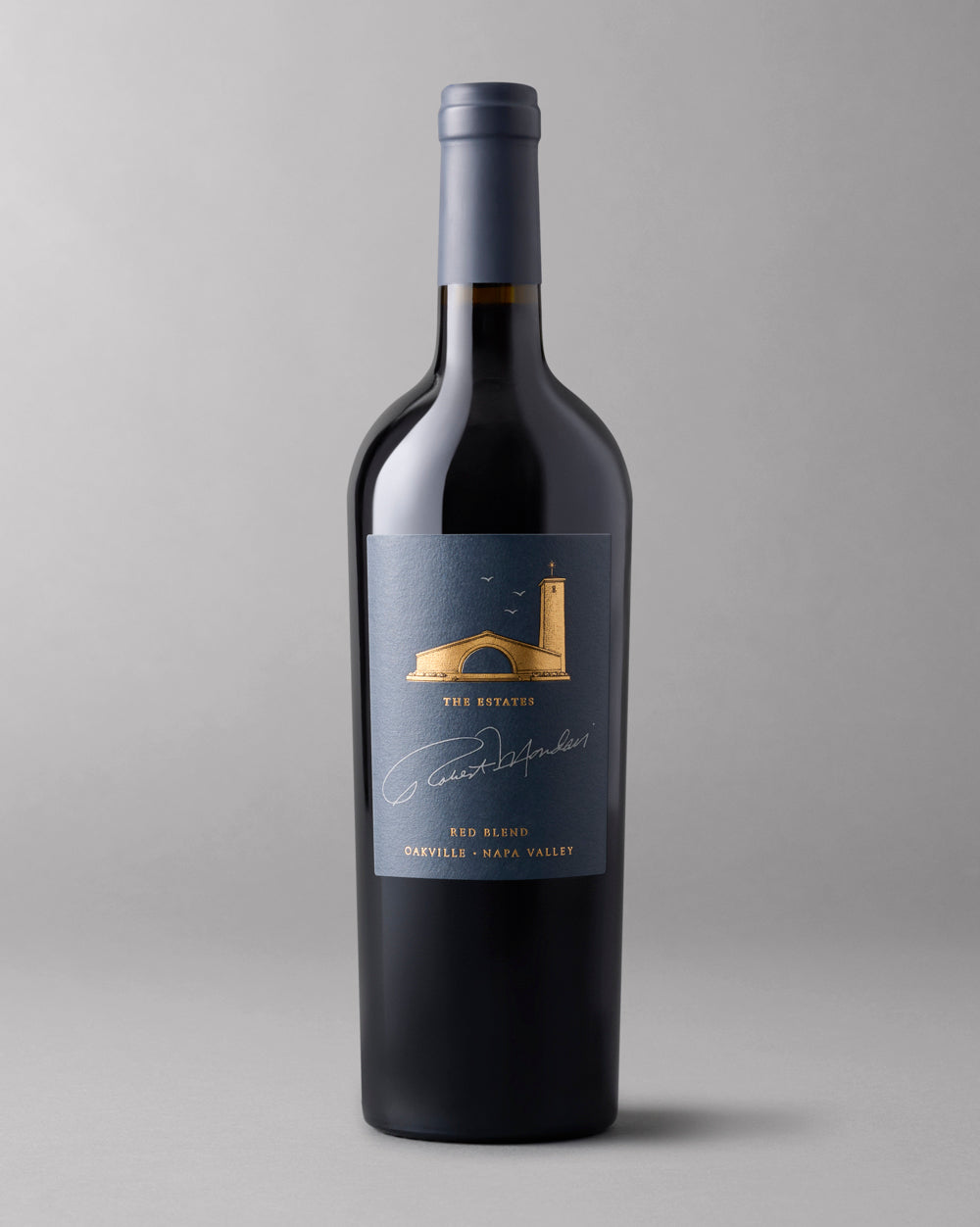 A bottle of 2021 The Estates Red Blend Oakville on a grey background.