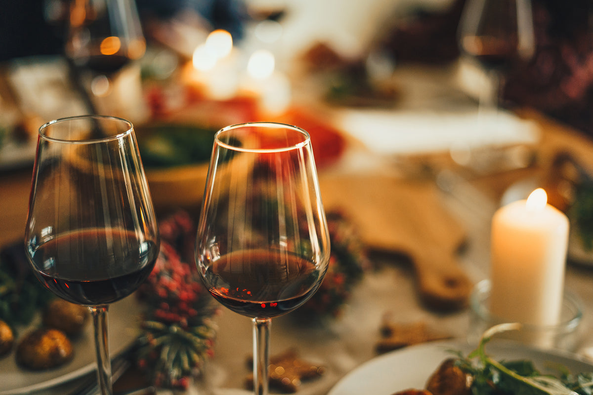 Two glasses of red wine at holiday dinner table