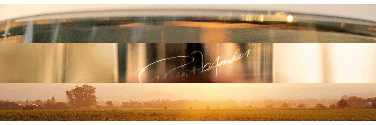 A horizontal band with a warm golden sunset landscape at the bottom and a dark reflective upper section featuring a white script signature that reads "Robert Mondavi"