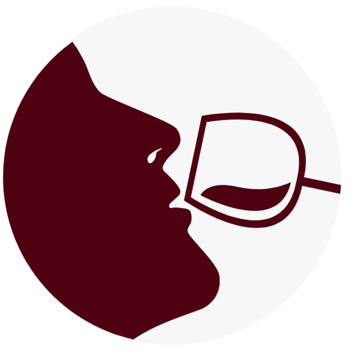 The silhouette of a person drinking from a wine glass.